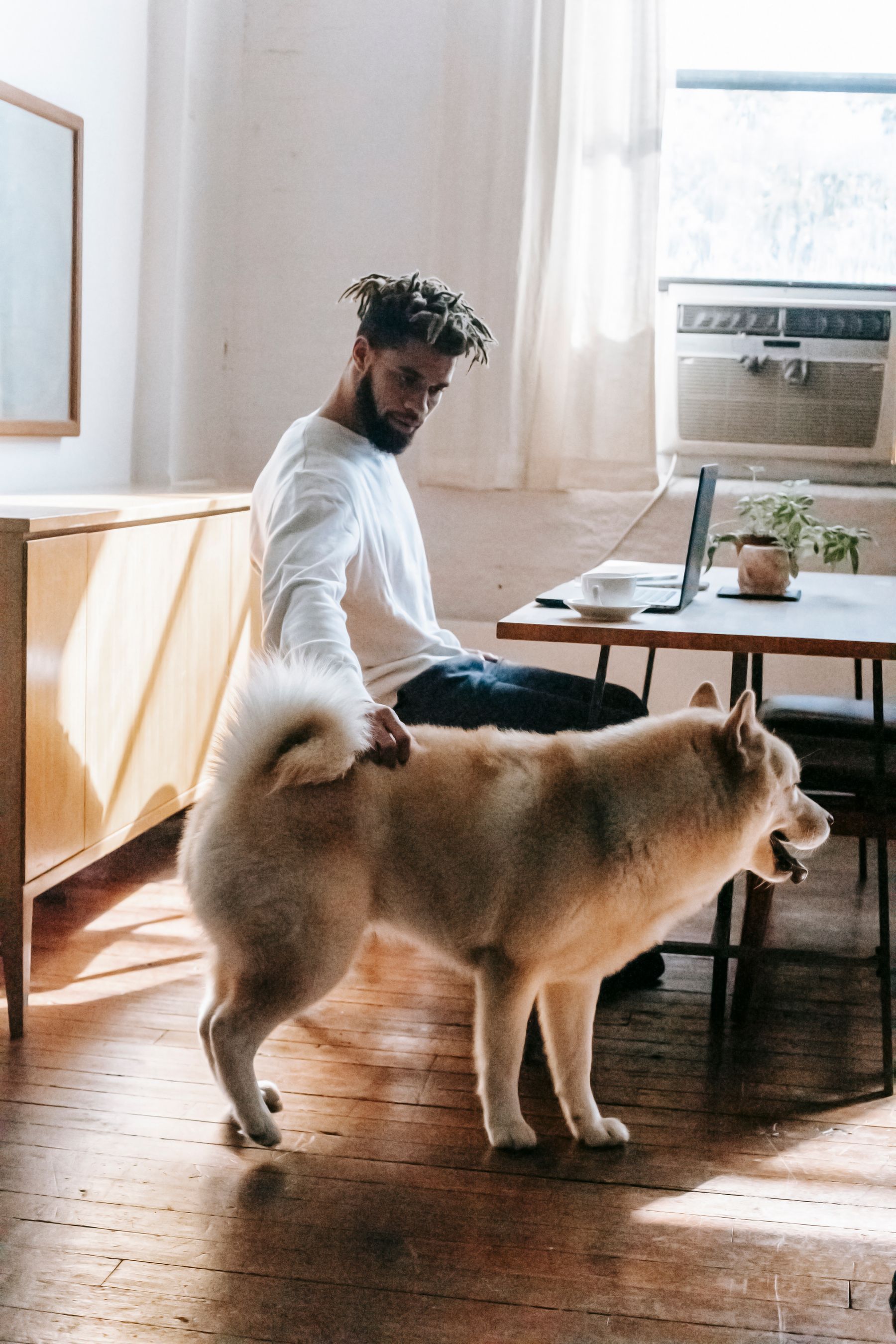 A friendly person outdoors with a dog